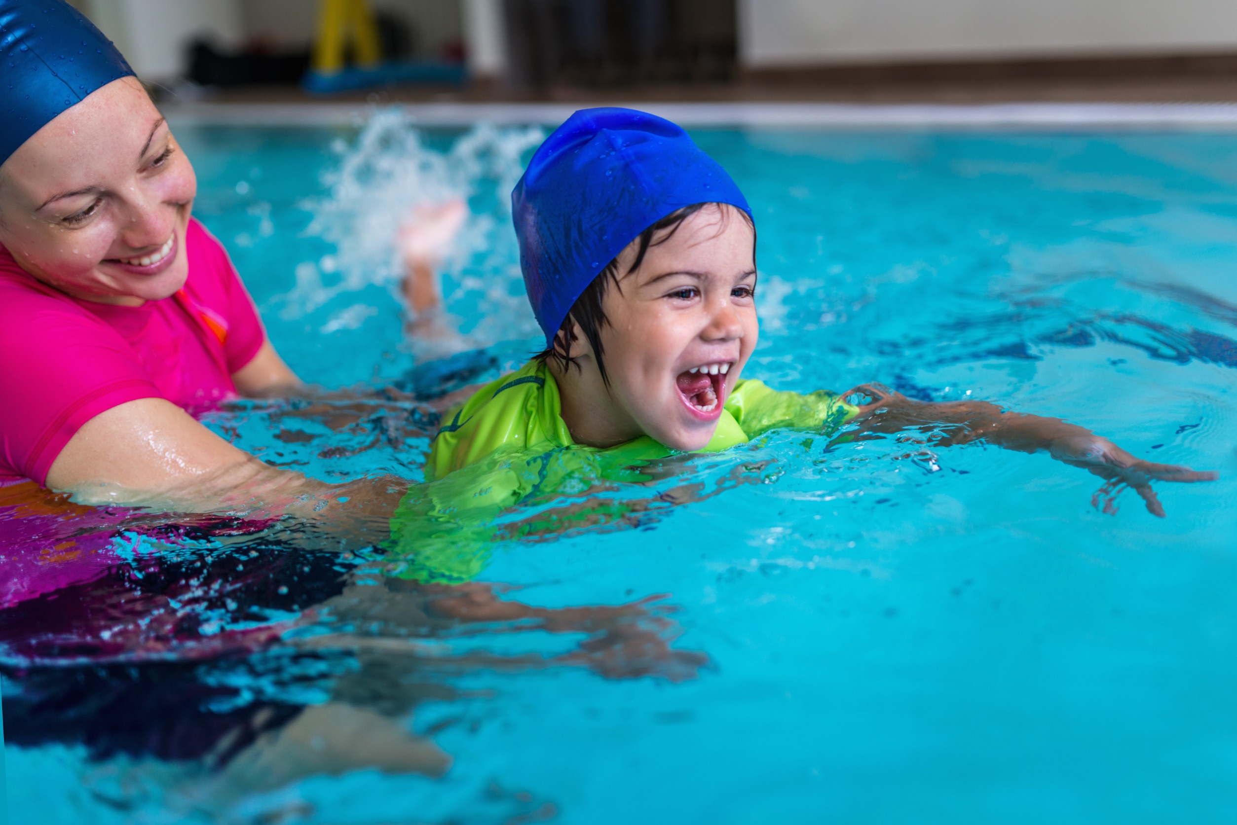 Child and parent practicing swimming