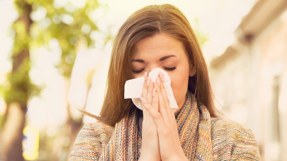 Woman blowing her nose