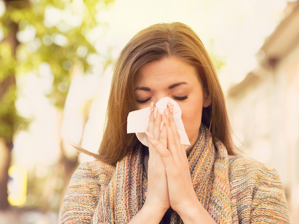 Woman blowing her nose