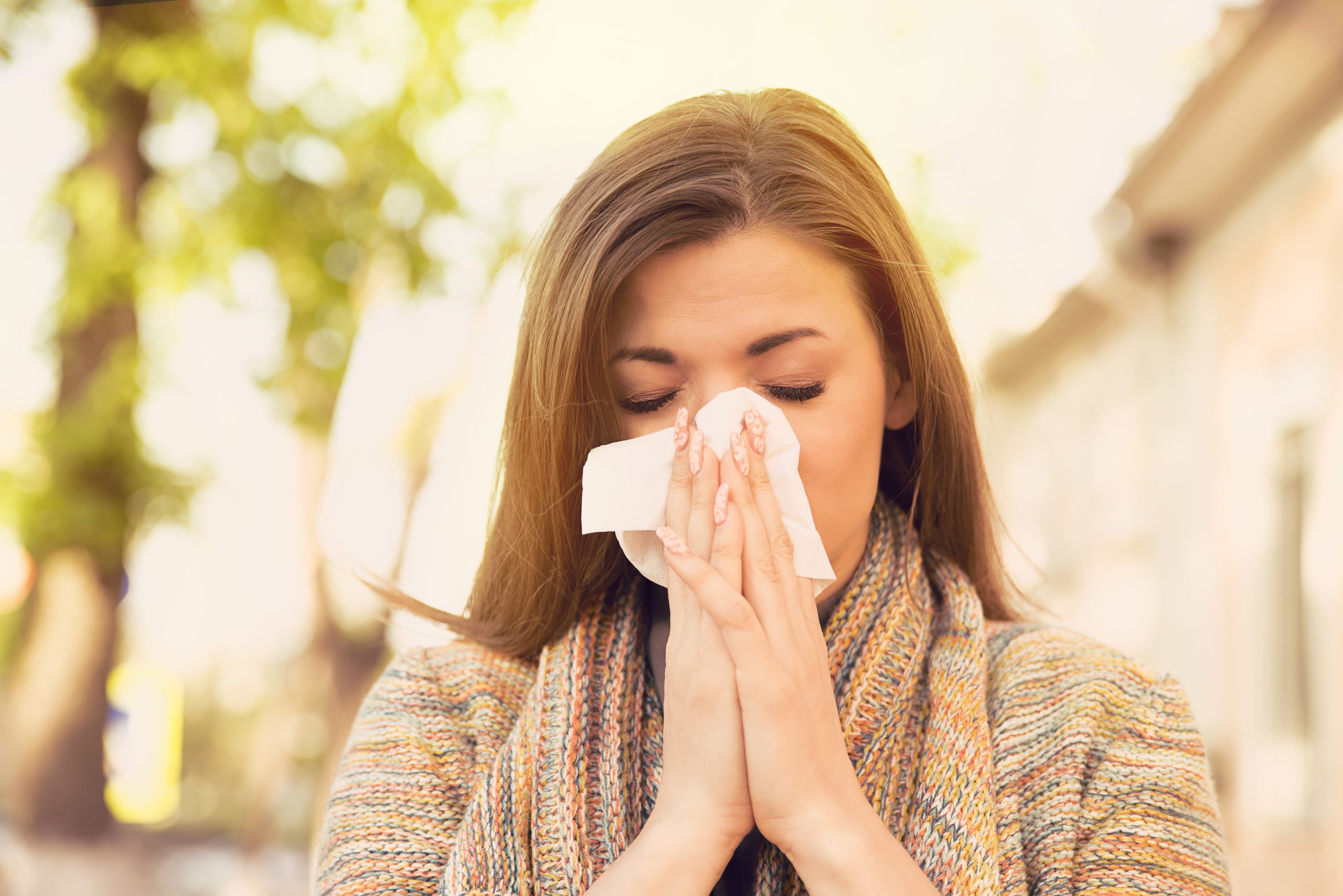 Woman blowing her nose