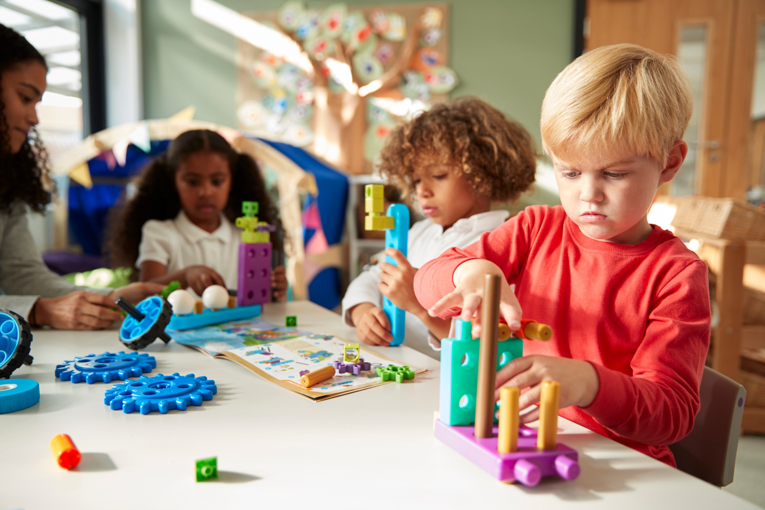 Children in kindergarten playing with building toys