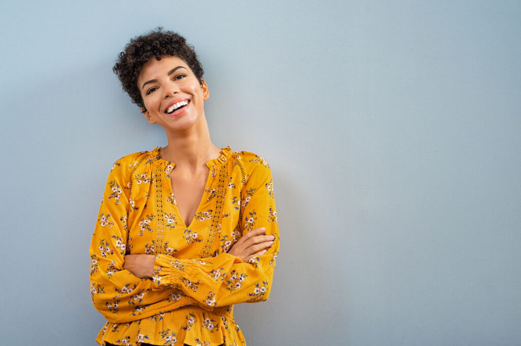 a smiling woman in a yellow top