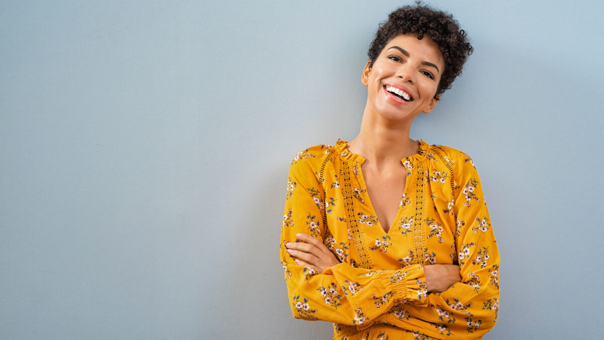 a smiling woman in a yellow top