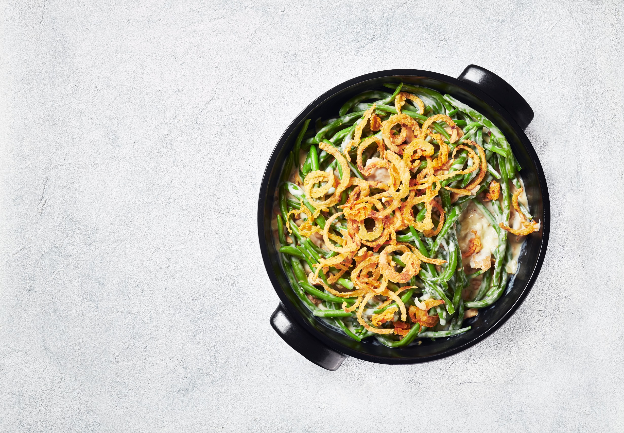 Green bean casserole served in a cast iron skillet.