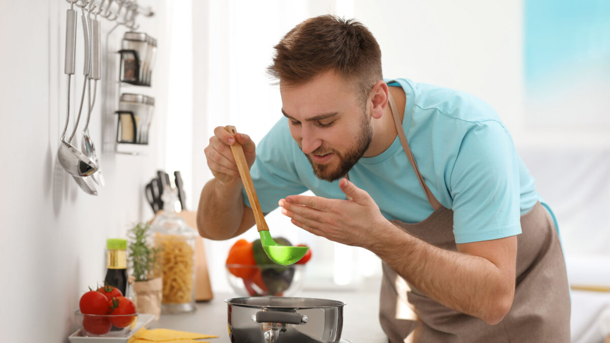 a man cooking soup in his kitchen