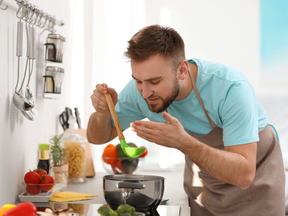 a man cooking soup in his kitchen