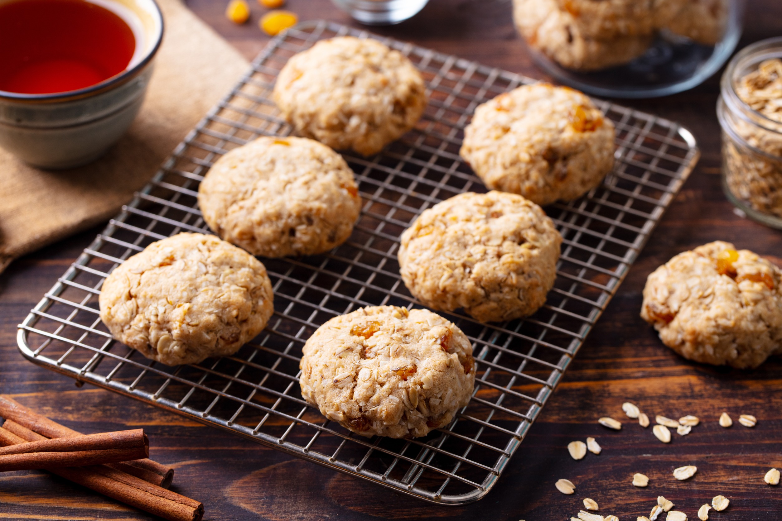 Cinnamon-raisin oatmeal cookies on a cooling rack.