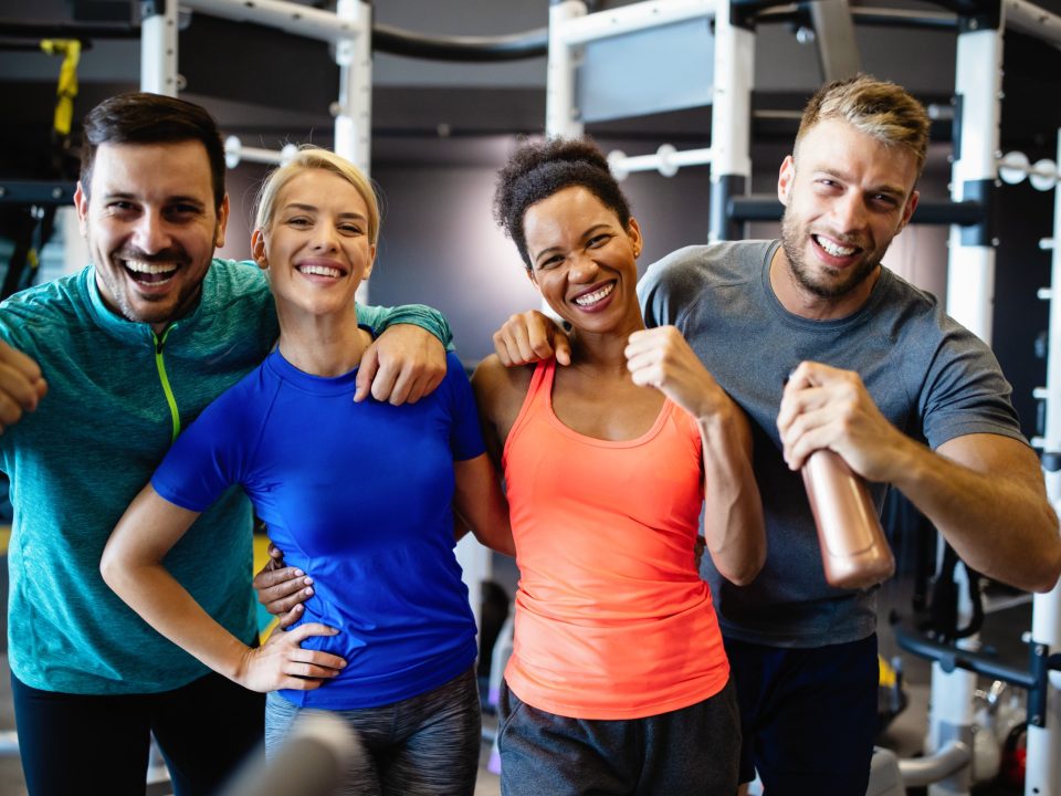 Happy adults smiling while working out