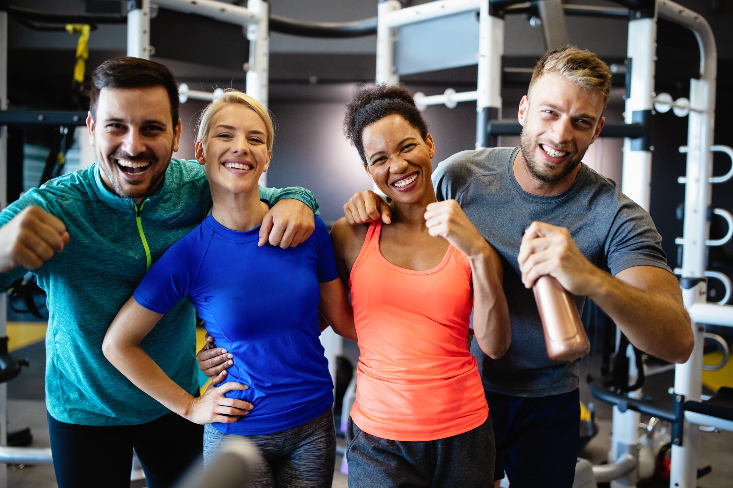 Happy adults smiling while working out