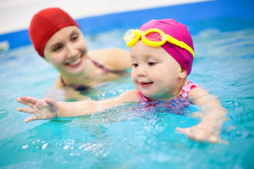 toddler in the pool with her mom