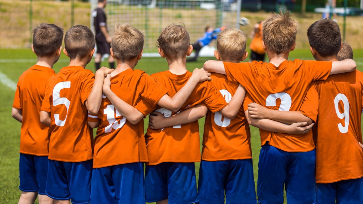 Children huddled together during a soccer game