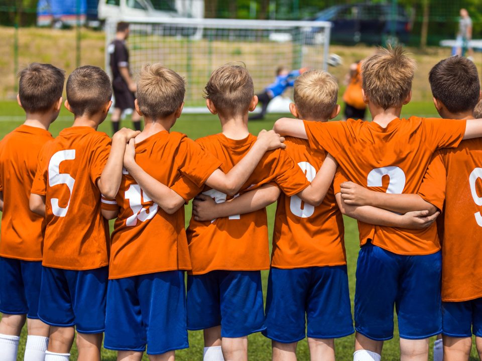 Children huddled together during a soccer game