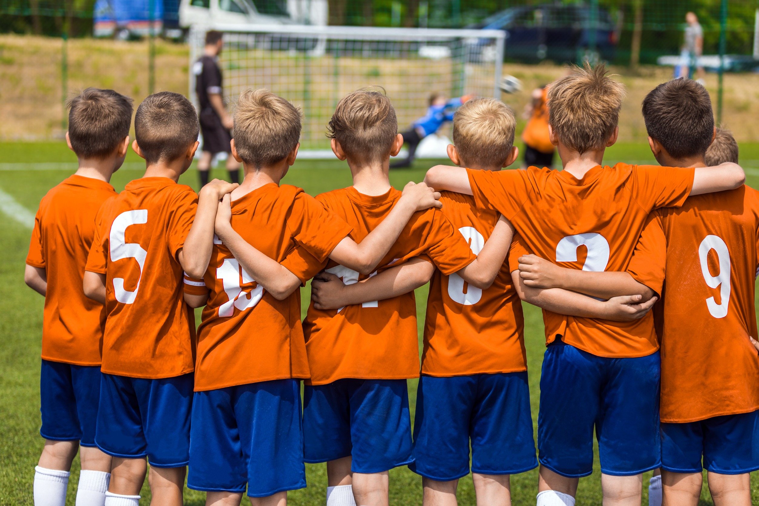 Children huddled together during a soccer game