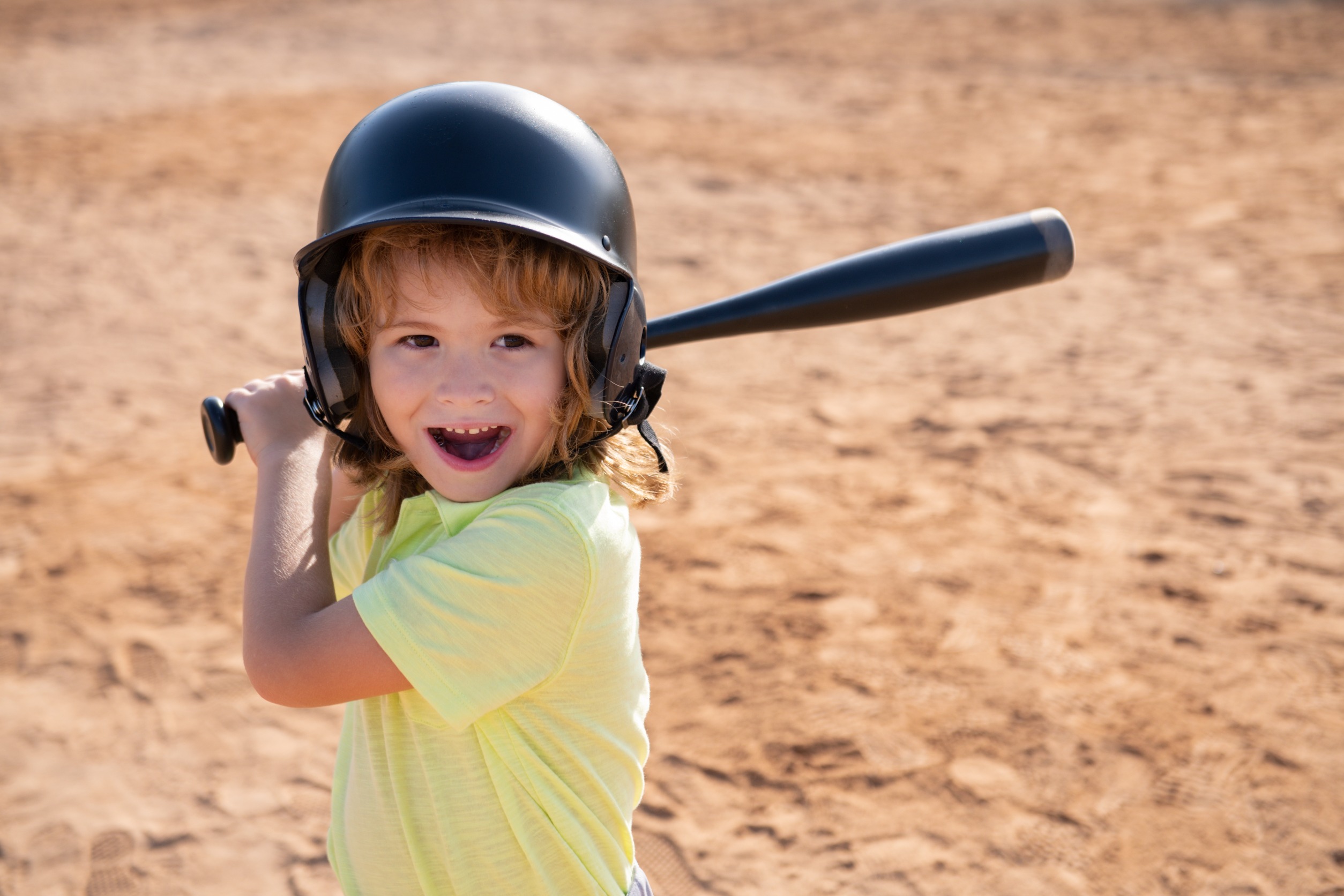 Child ready to play t-ball, one of the youth sports offered at the Y