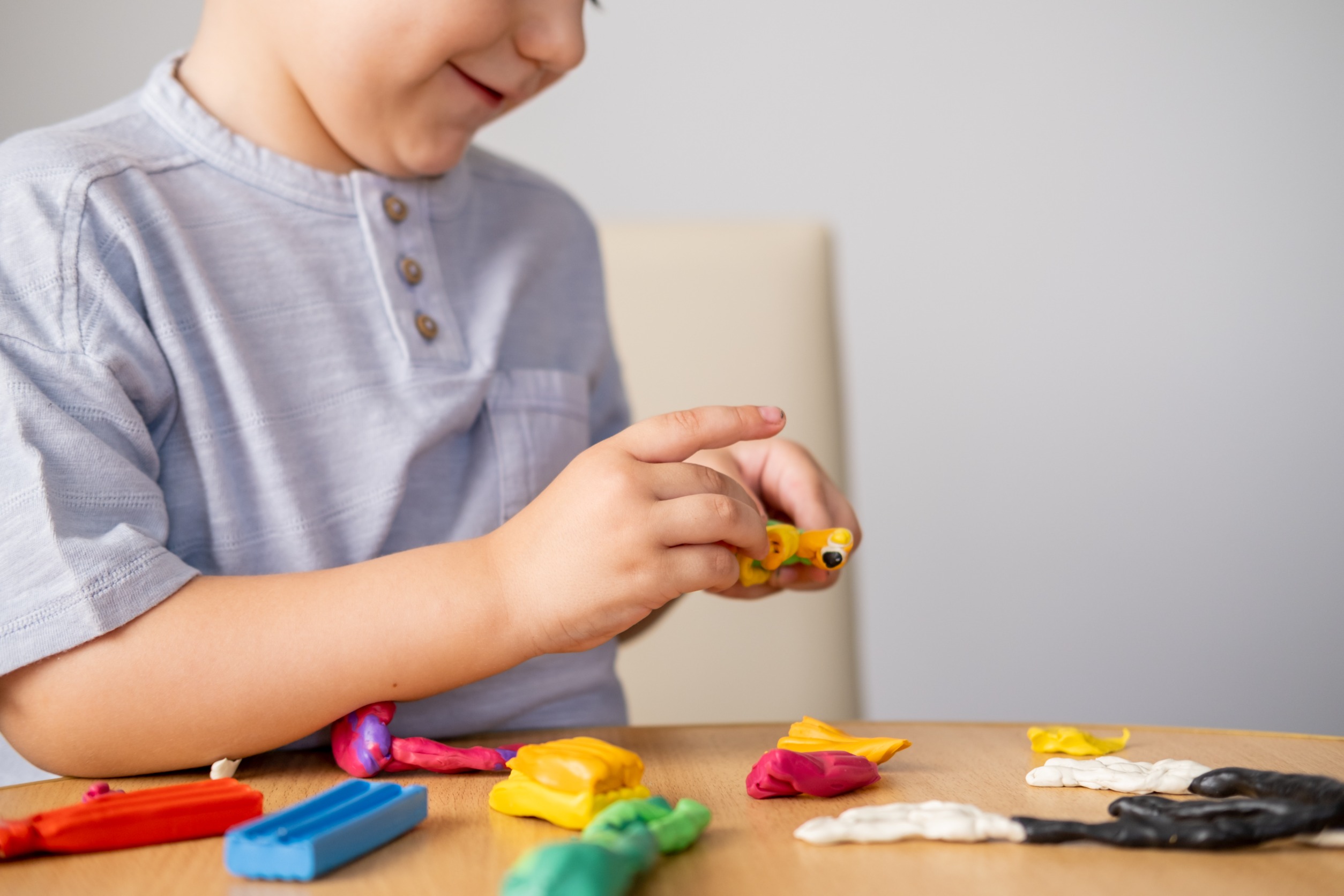 Child playing with clay by himself