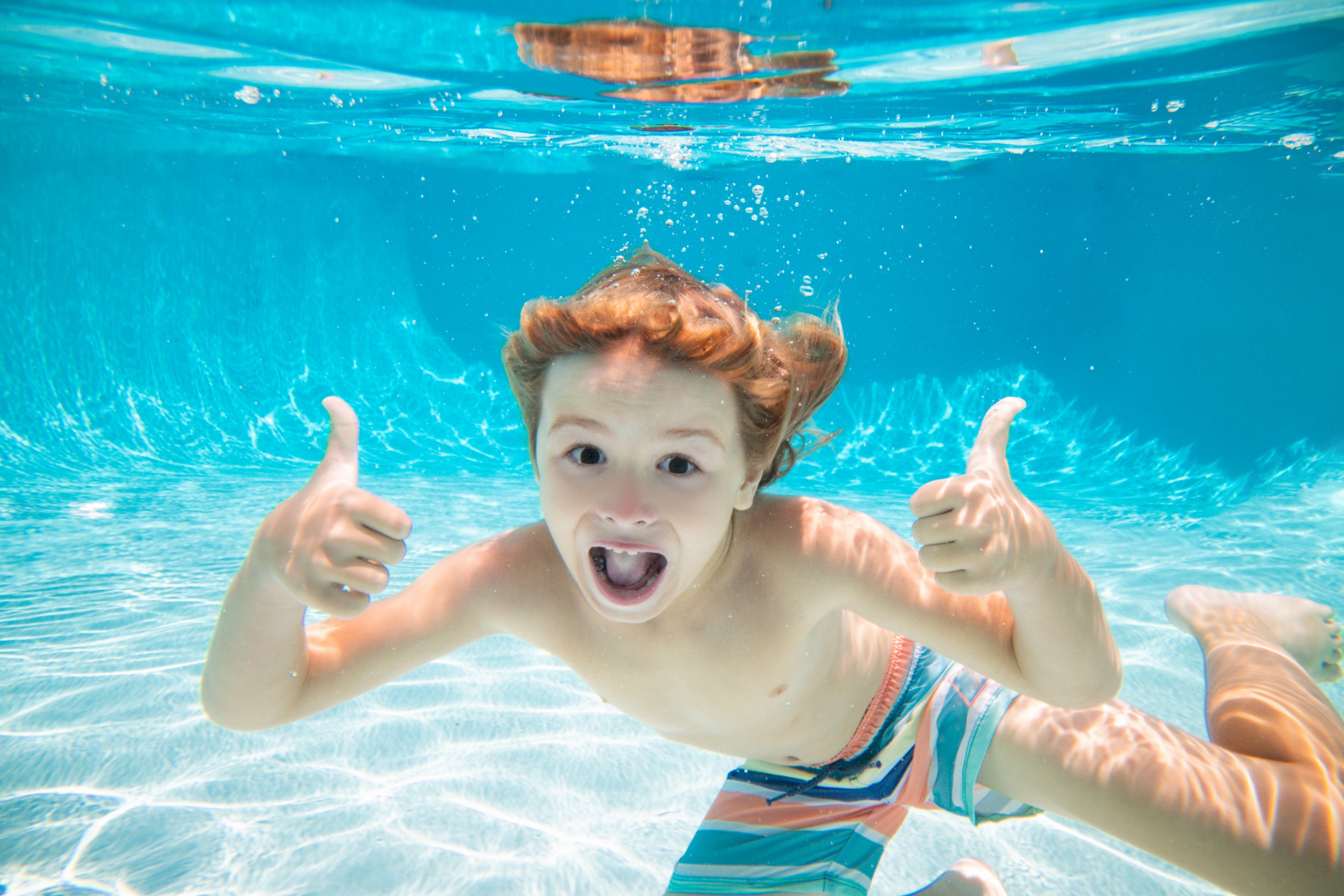 Young boy swimming underwater