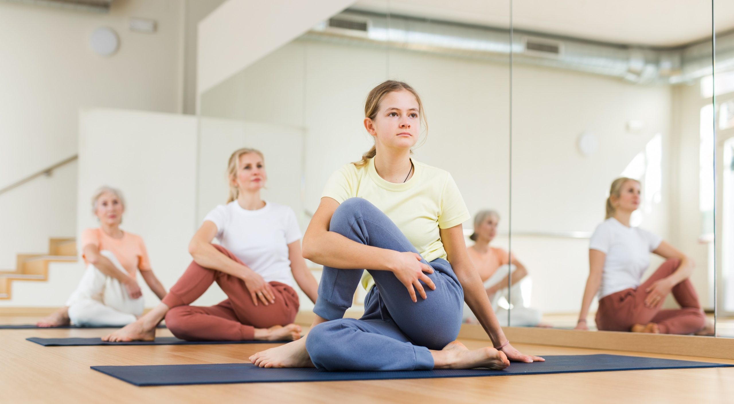 Teen stretching in group class