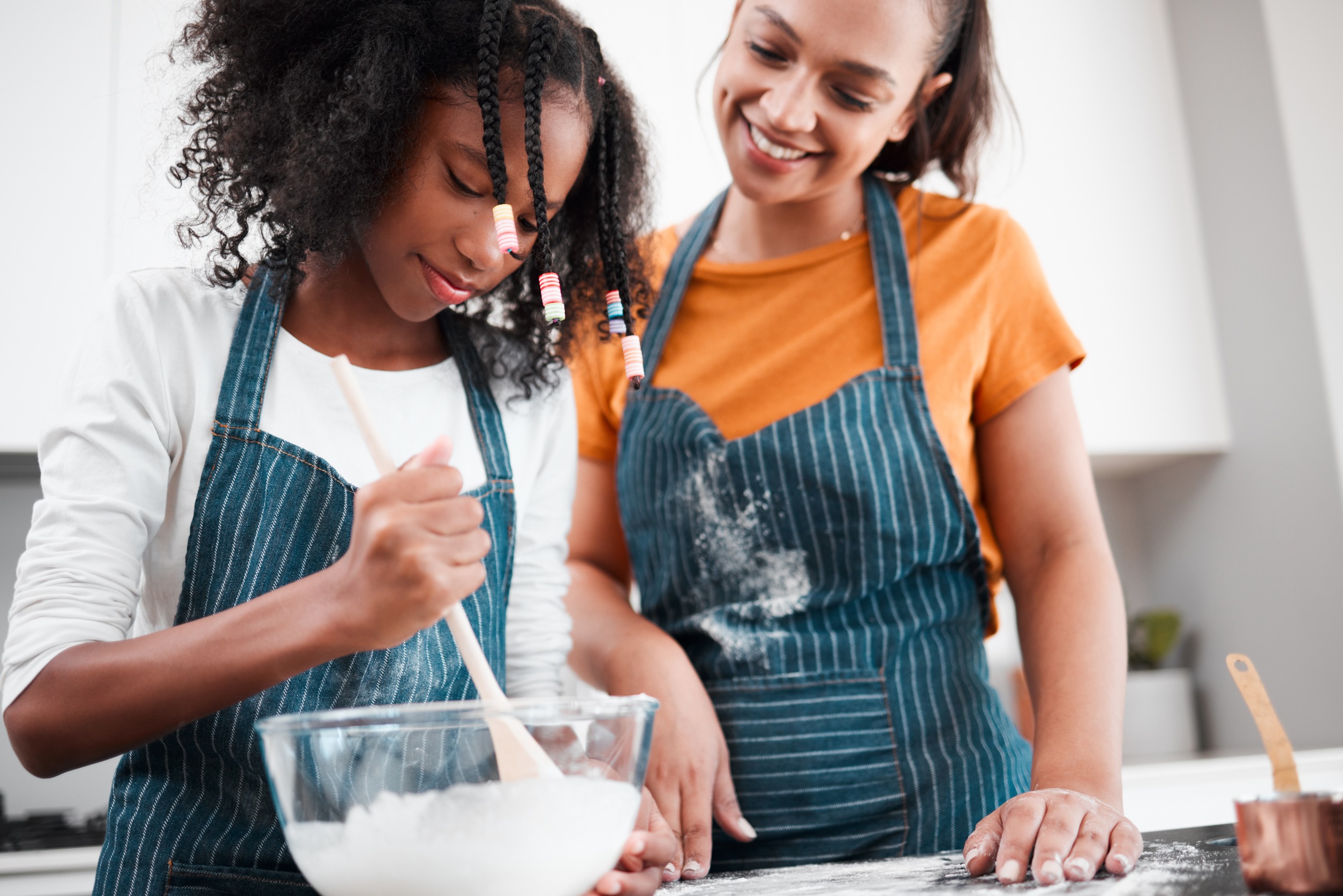 Mother and daughter baking together