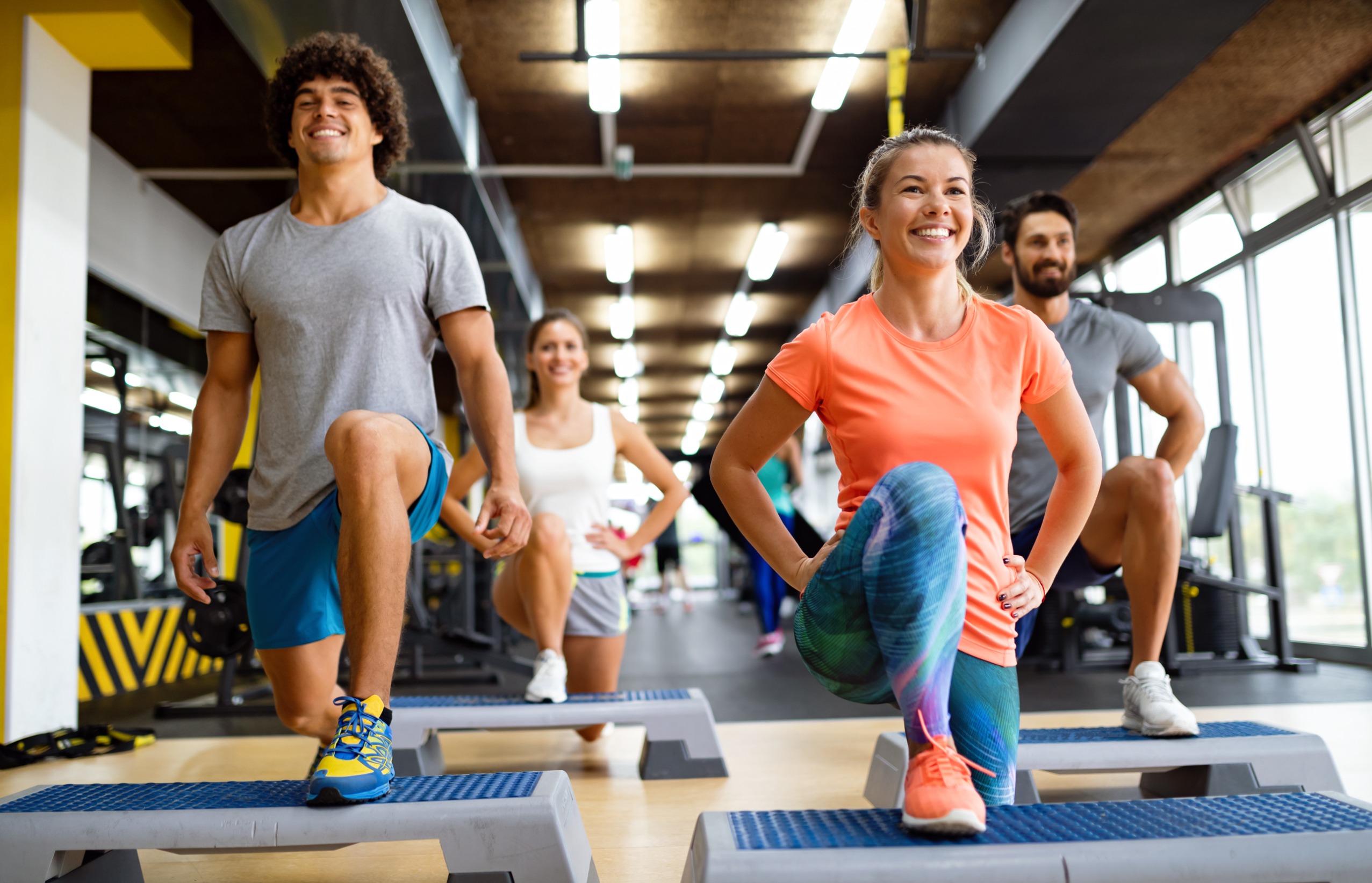 A group of young people trying a group fitness class.