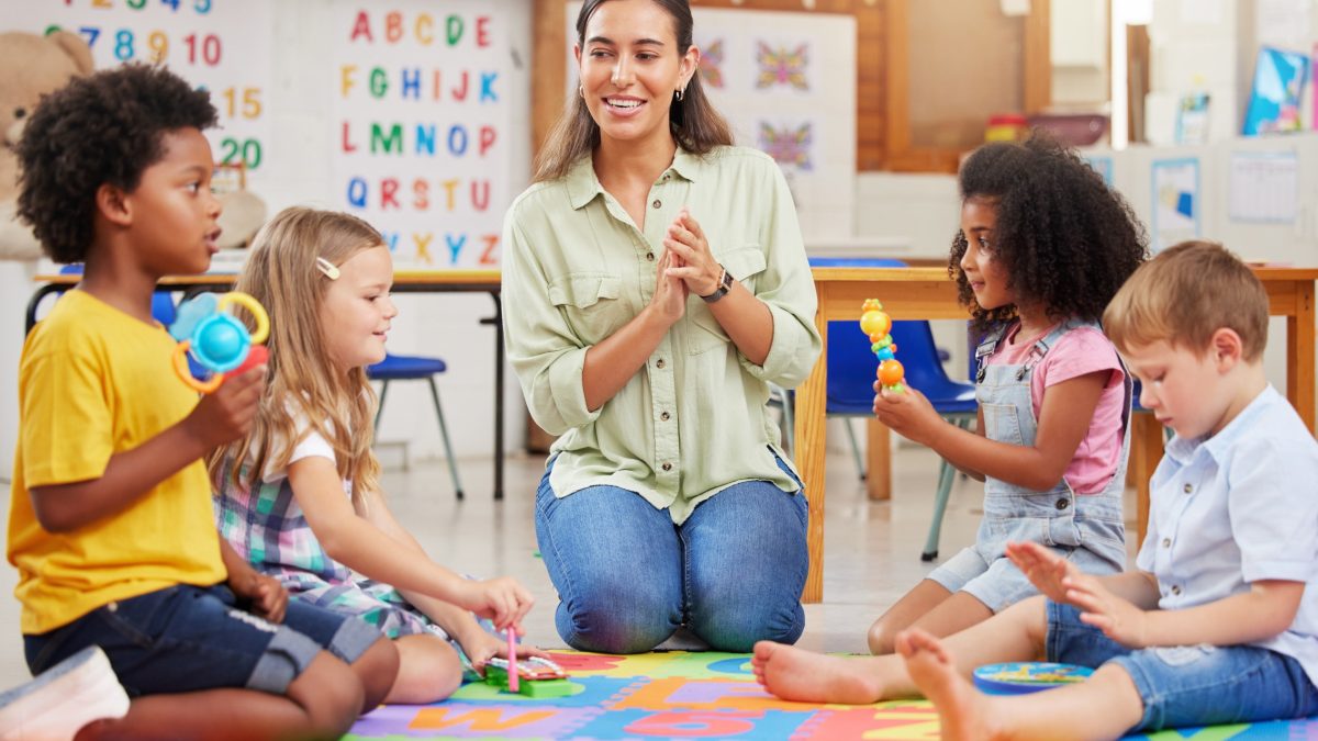 Children listening to caretaker at daycare