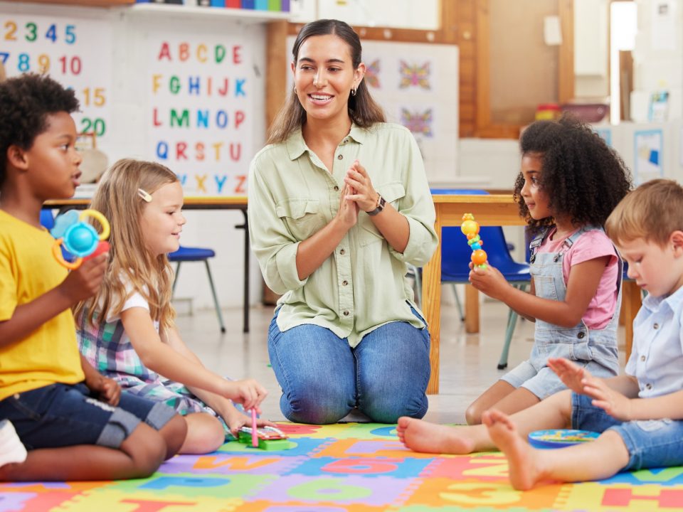 Children listening to caretaker at daycare