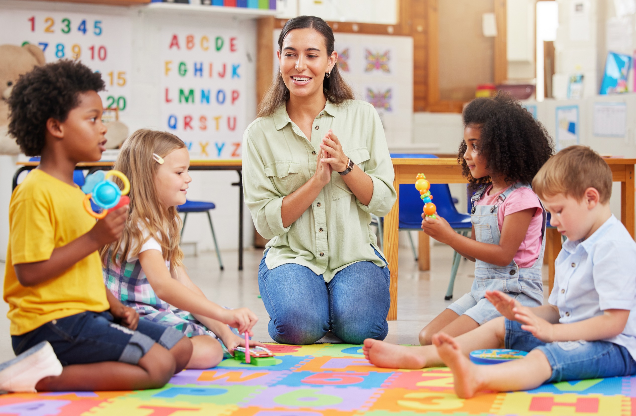 Children listening to caretaker at daycare