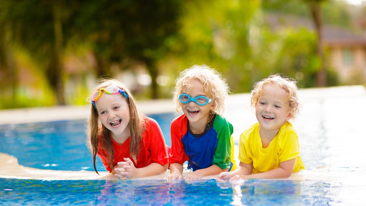 Kids on a floaty in a pool