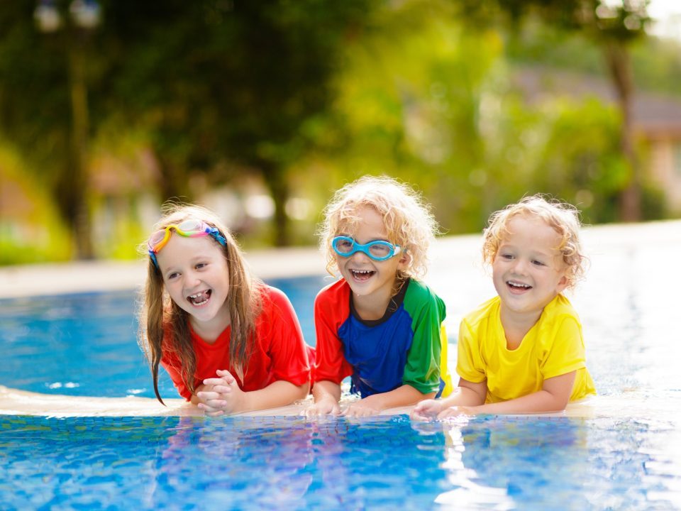 Kids on a floaty in a pool