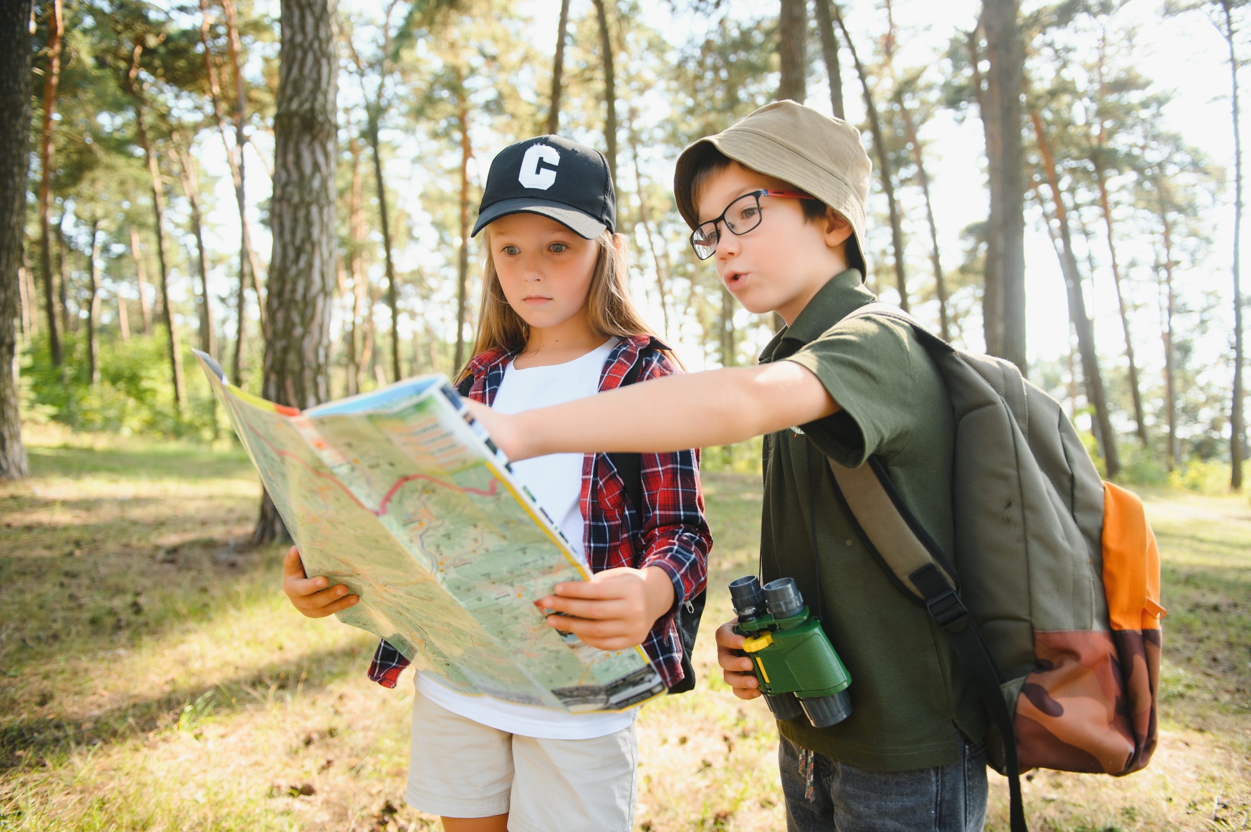 Kids hiking and looking at map