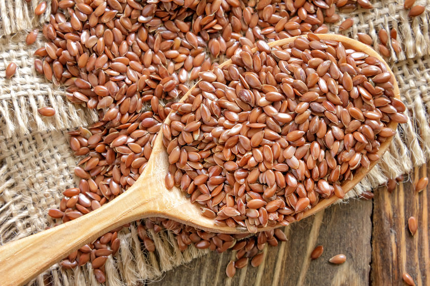 flaxseeds on a spoon and table