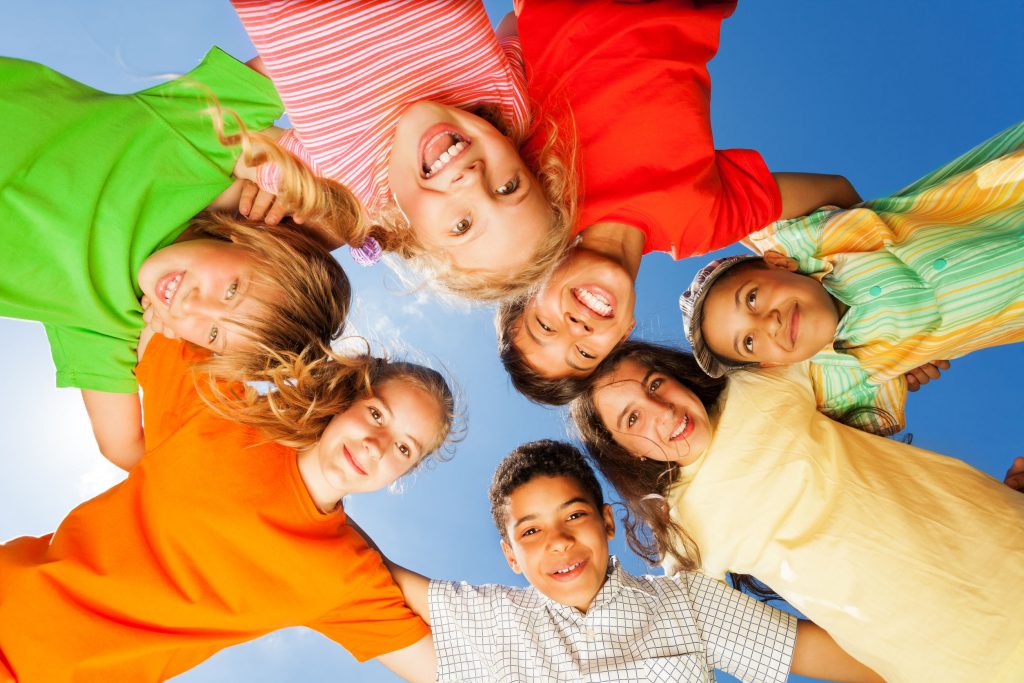 a team of boys and girls huddled together in a circle