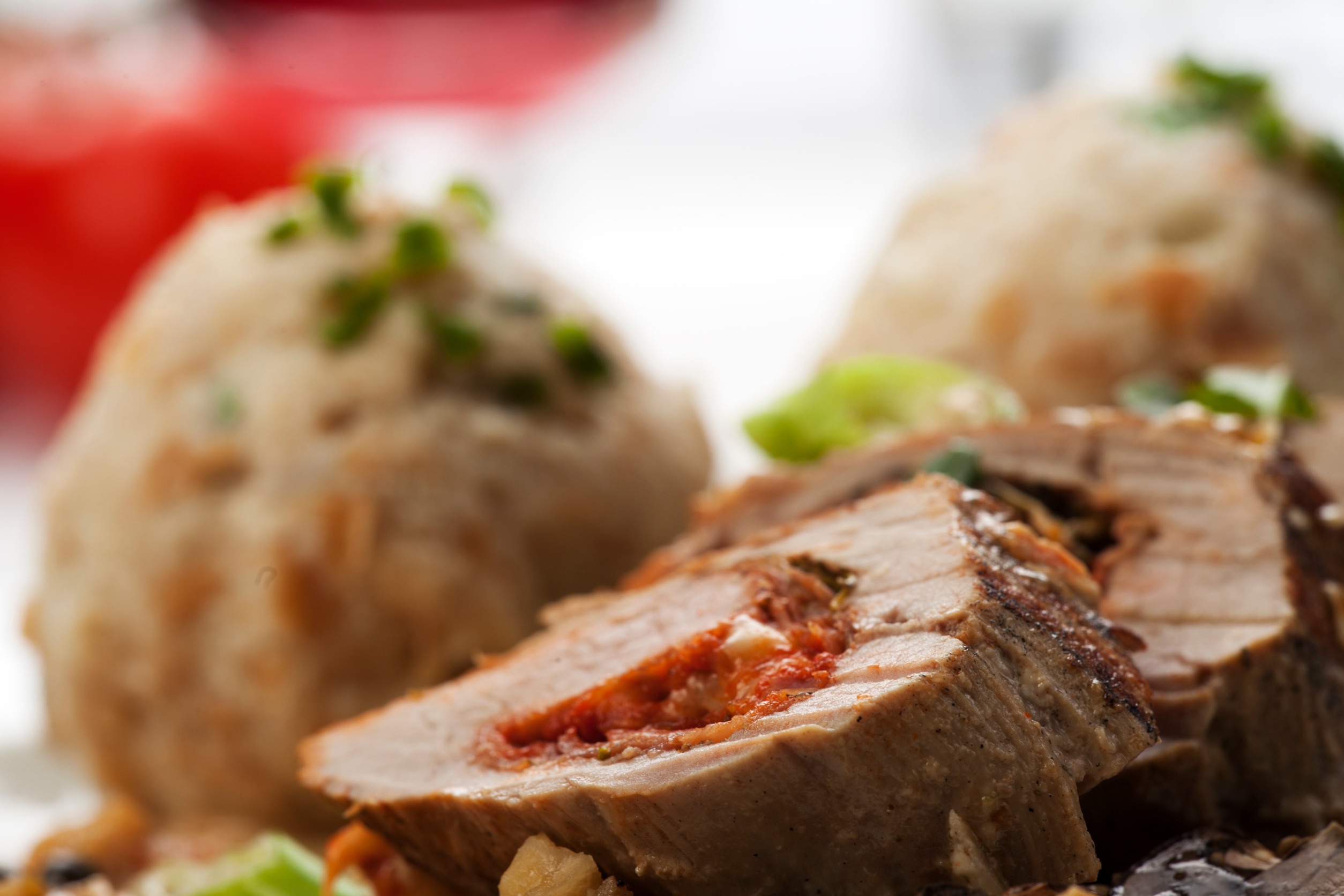 Stuffed pork tenderloin served on a plate.