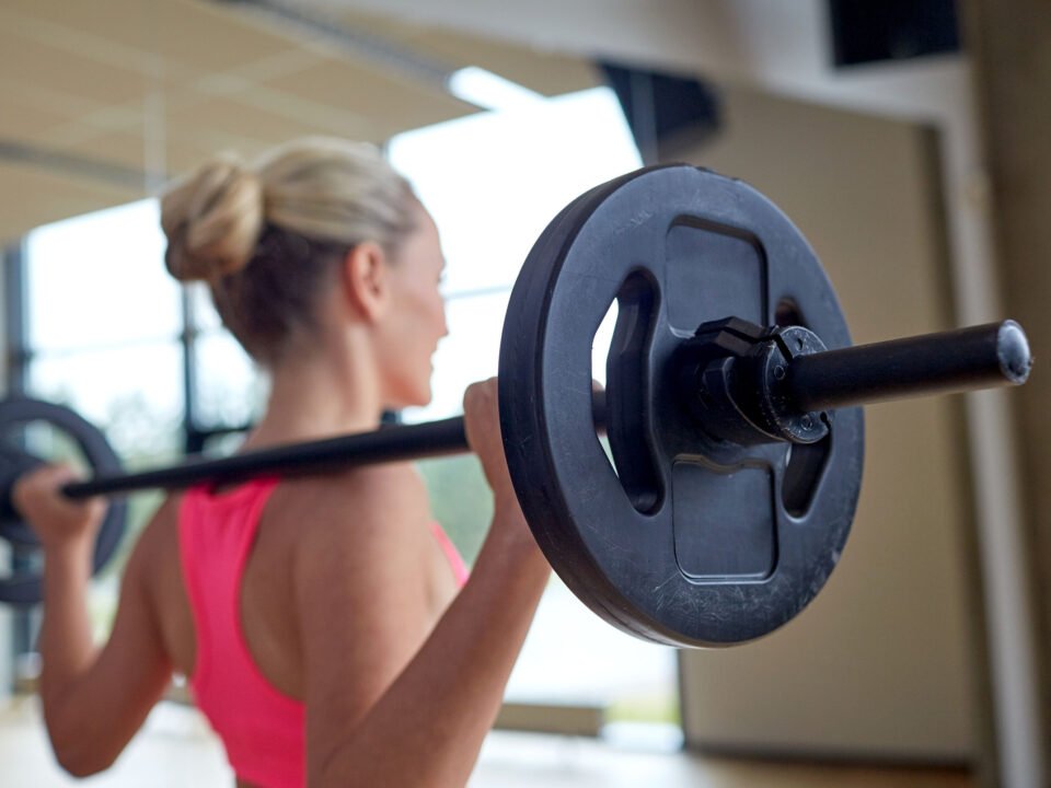 a woman lifting weights at the gym