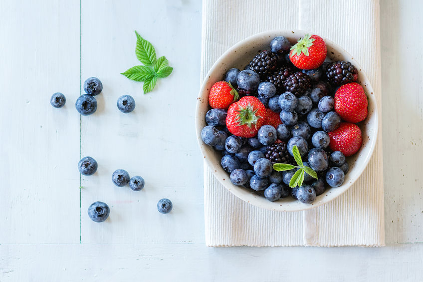 blueberries, blackberries, and strawberries in a white bowl