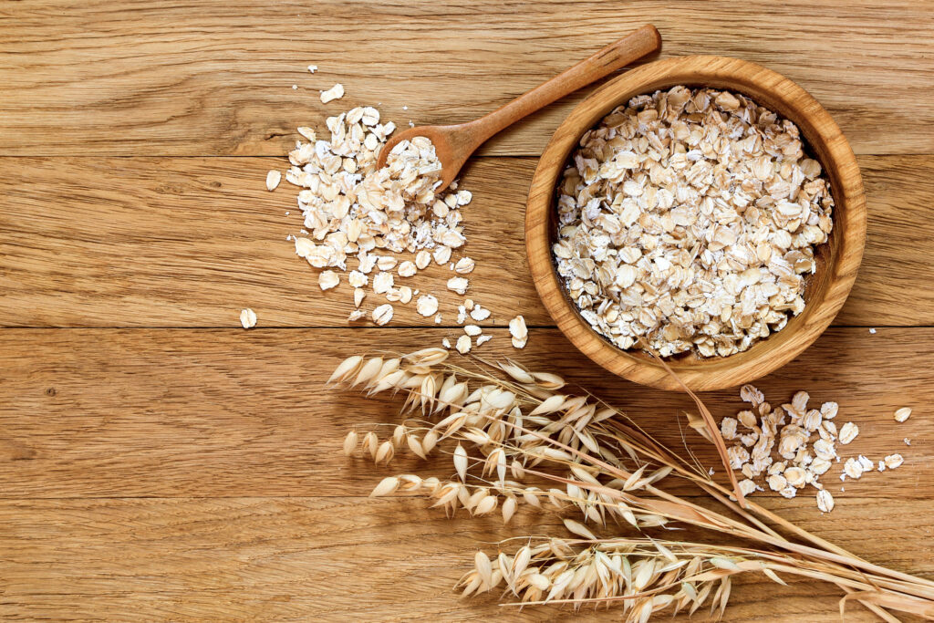 barley and a bowl of oats on a wooden table