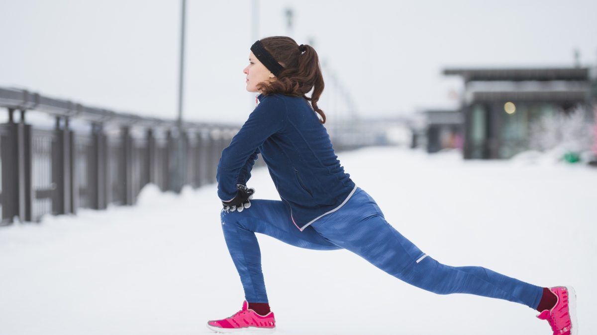 Woman stretching in the snow