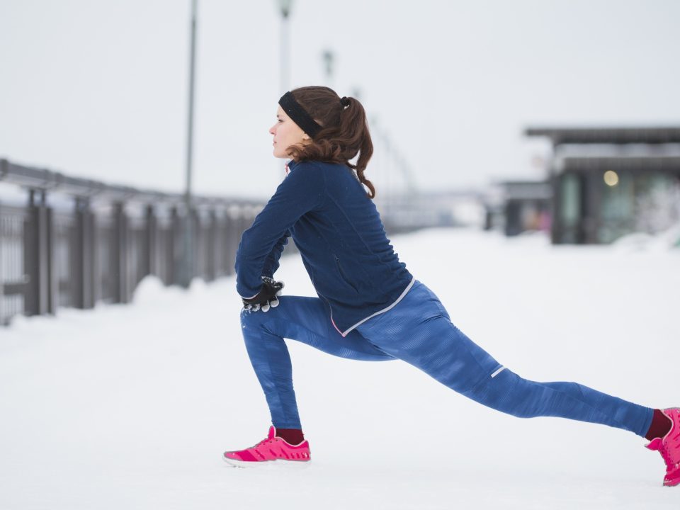 Woman stretching in the snow