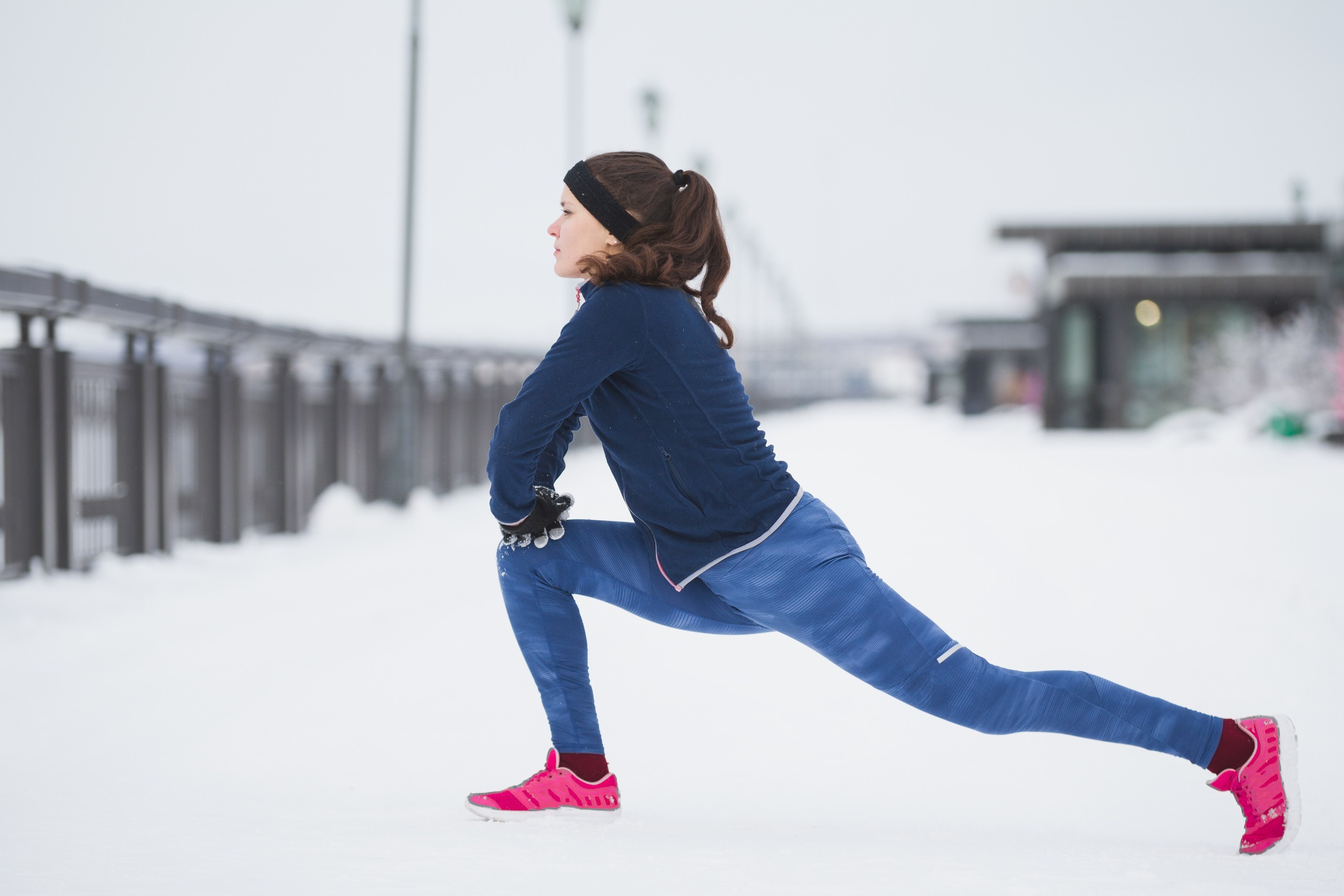 Woman stretching in the snow