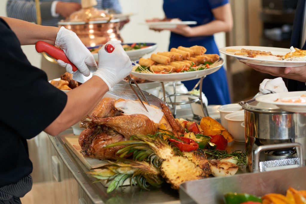 Thanksgiving buffet that offers white meat turkey, fried foods, veggies, grilled pineapple, and other choices