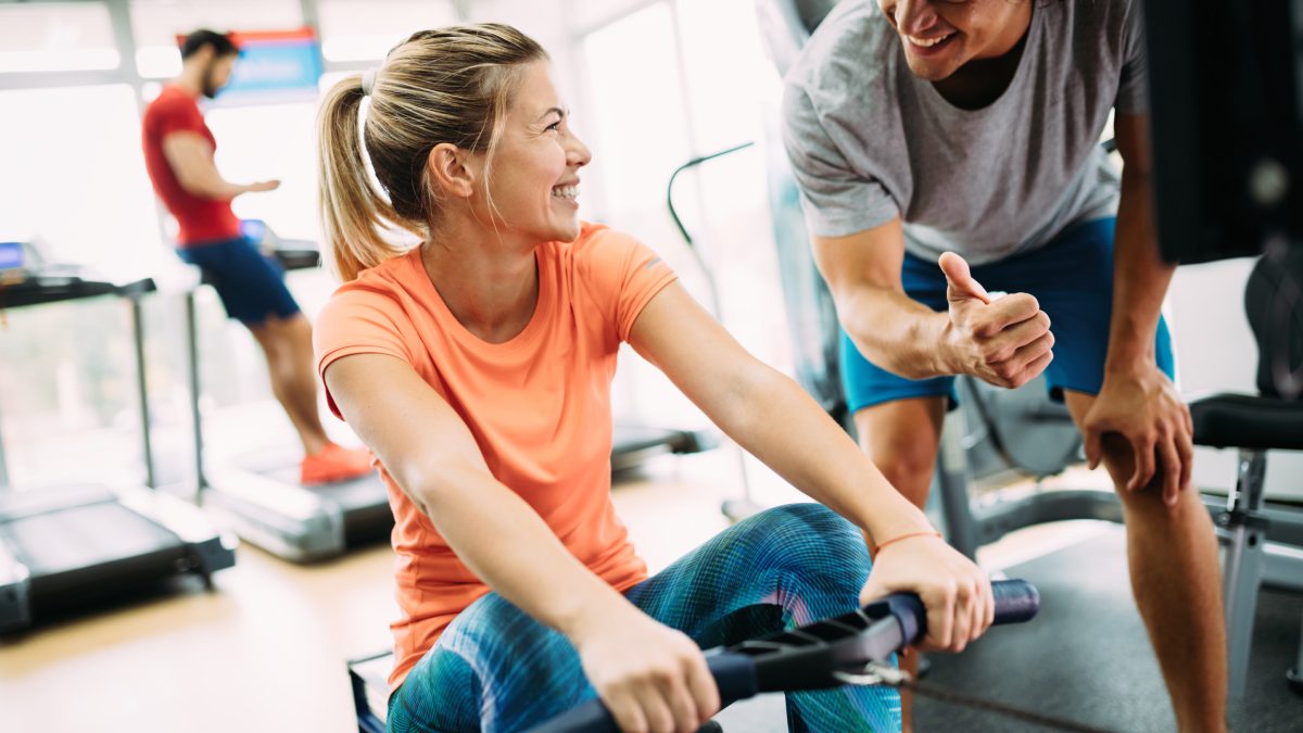 A personal trainer encouraging their client.