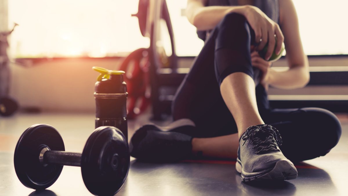 Woman working out with weights at the gym.