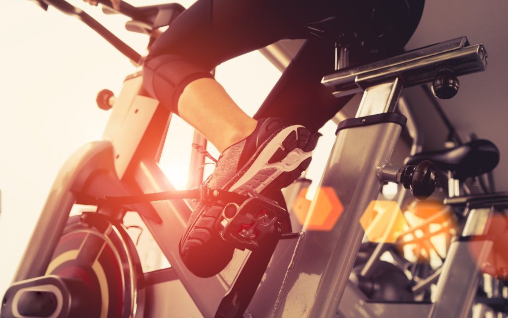 Woman riding a stationary bike.