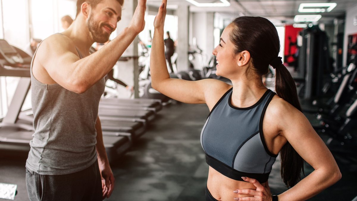 Couple giving each other a high five after a partner workouts.