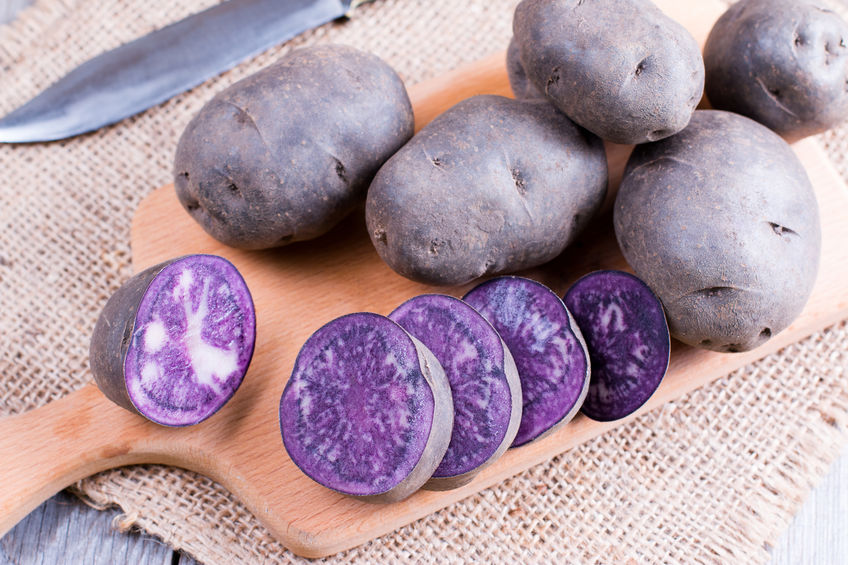 purple potatoes on a wooden table