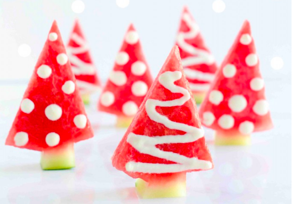 Christmas trees made out of watermelon triangles, rinds for the trunk, and yogurt for decoration