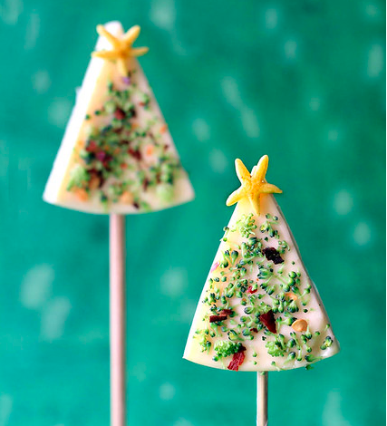 Christmas trees made from cheese wedges, shaved broccoli florets, chili pepper flakes, and yellow pepper (for the star)