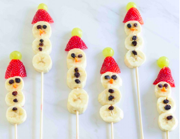 cute snowmen made from bananas, strawberries, carrots, raisins, and grapes