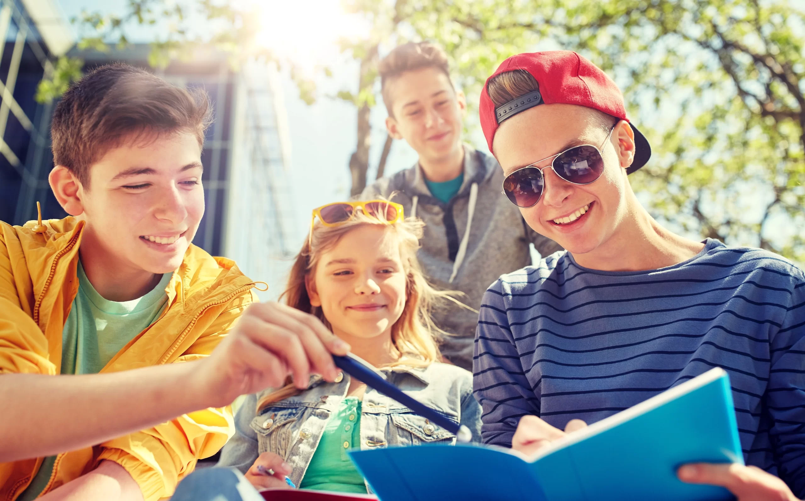 Teens looking at notebook