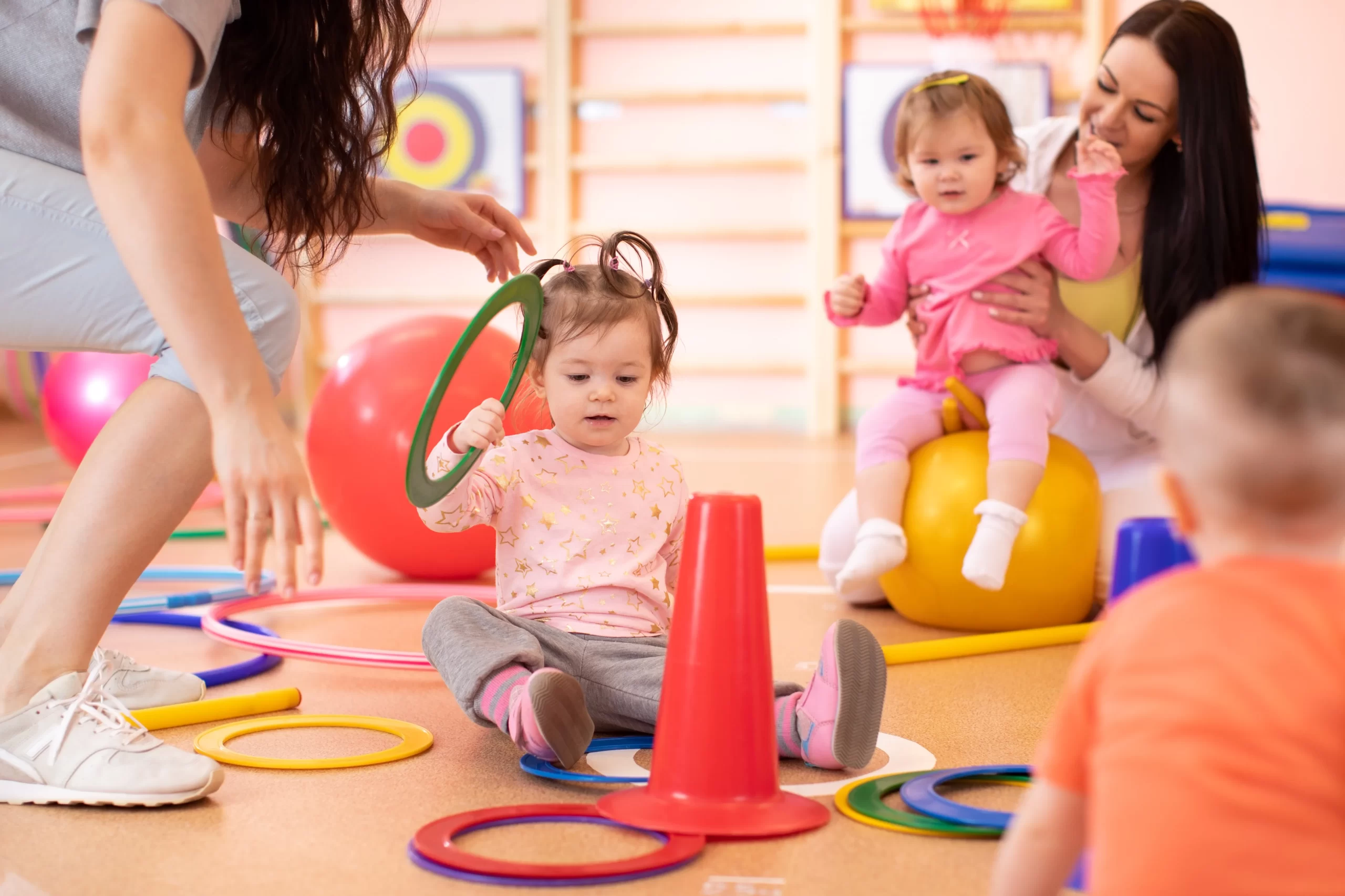 Daycare staff playing with children